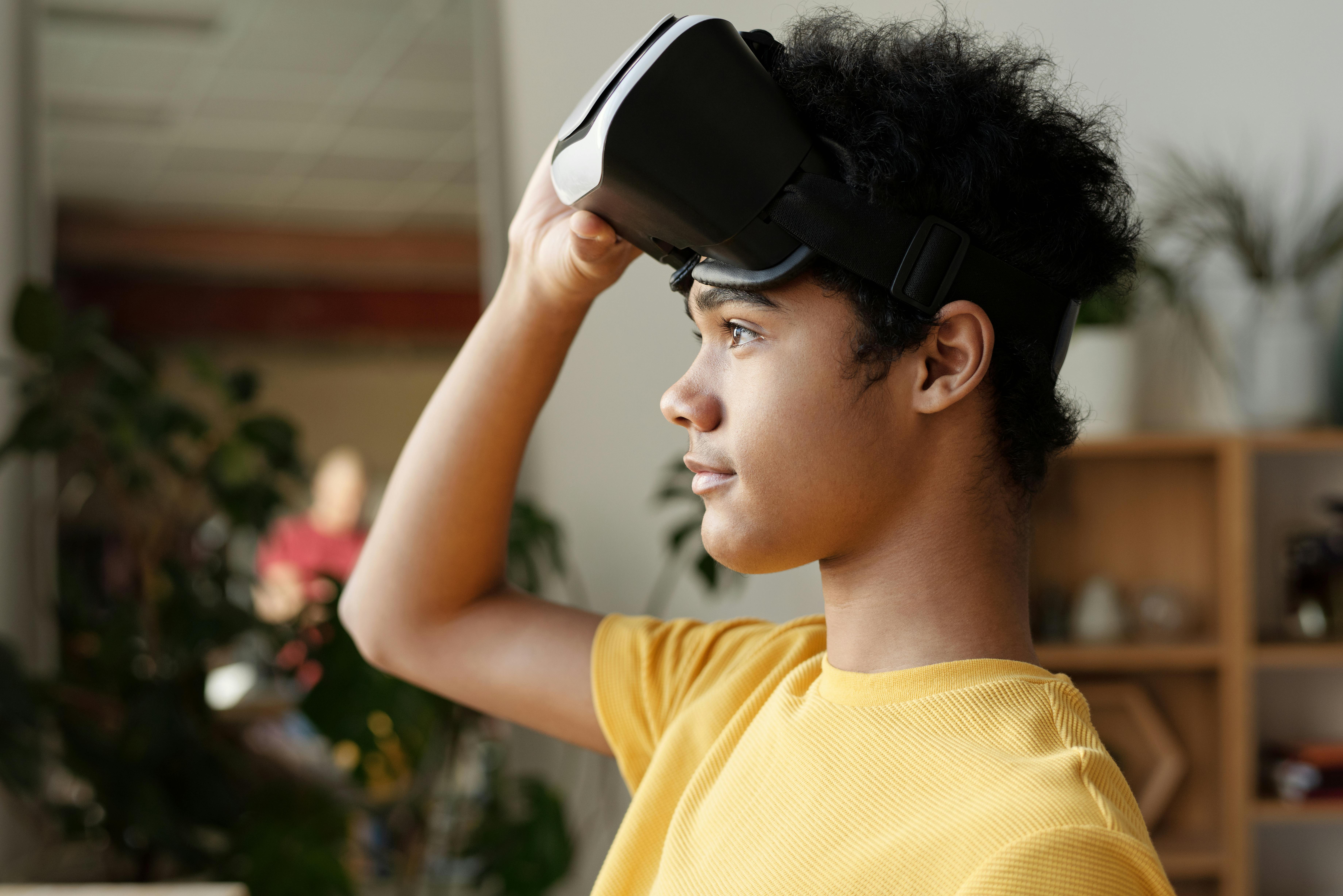 photo of boy holding vr headset