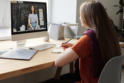 Free Girl Watching Video Using Imac Stock Photo