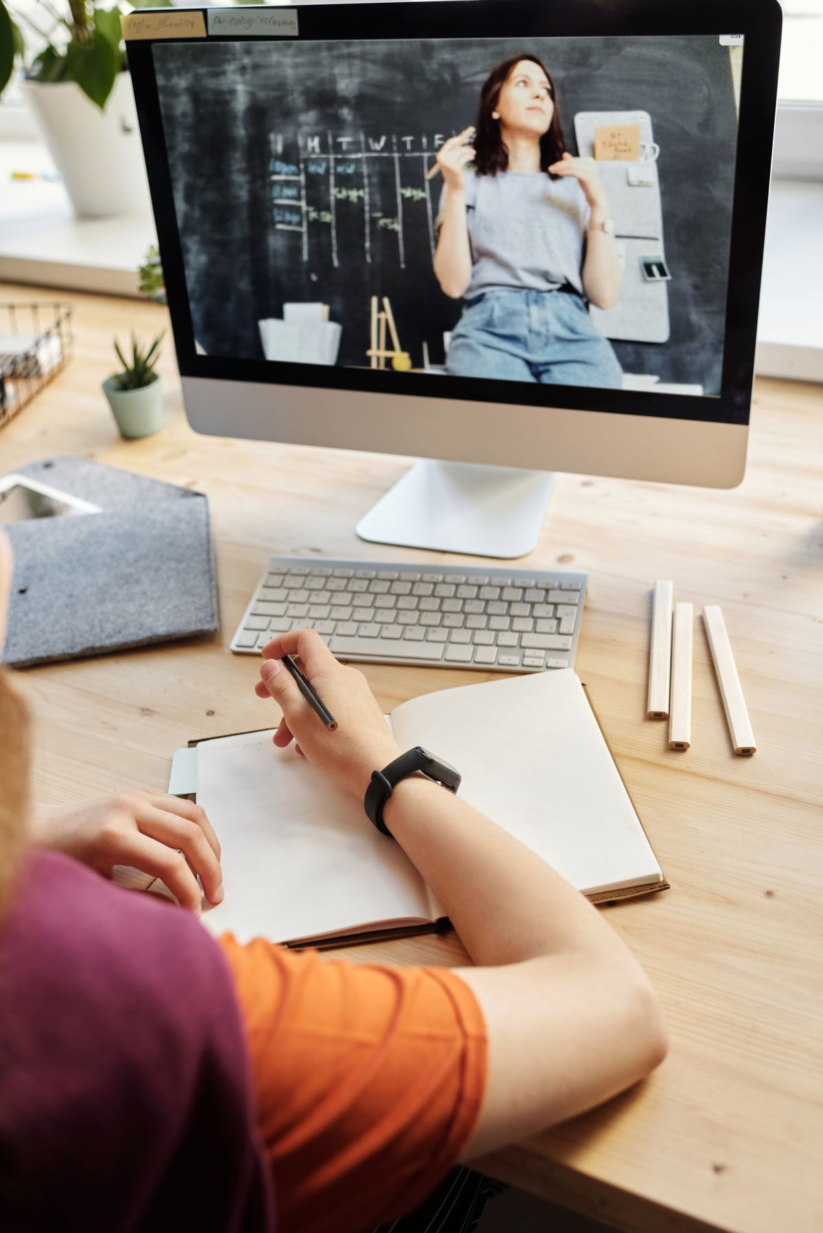 Professional looking at laptop with healthy breakfast