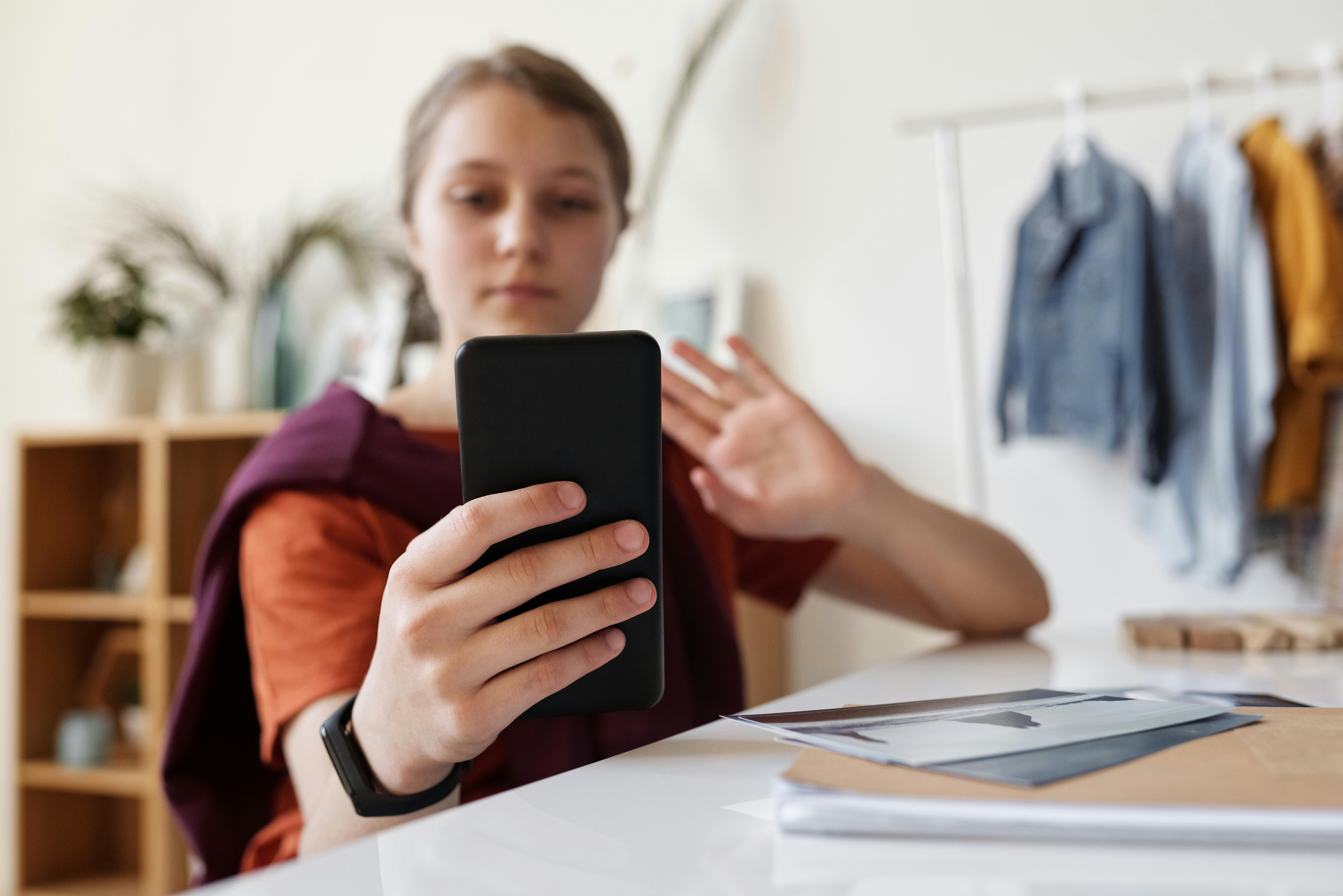 girl holding black smartphone