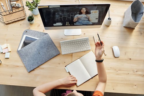 Free Top View Photo of Girl Watching Through Imac Stock Photo