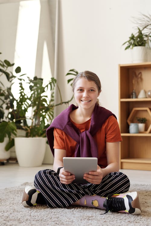 Free Girl Smiling While Holding Silver Ipad Stock Photo