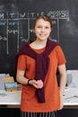 Girl in Orange Shirt Smiling While Holding Pink Kinetic Sand