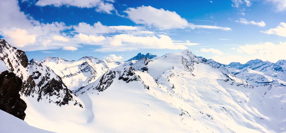 Breathtaking panoramic view of the snow-capped mountains in the Austrian Alps during winter.