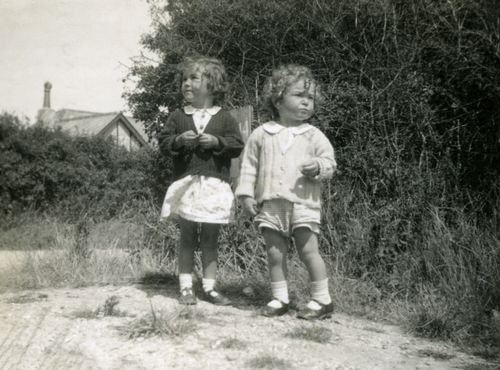 Free Charming vintage photo of children standing outdoors, capturing a moment in time. Stock Photo