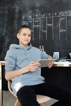 Teen studying with tablet in a modern home classroom setup.