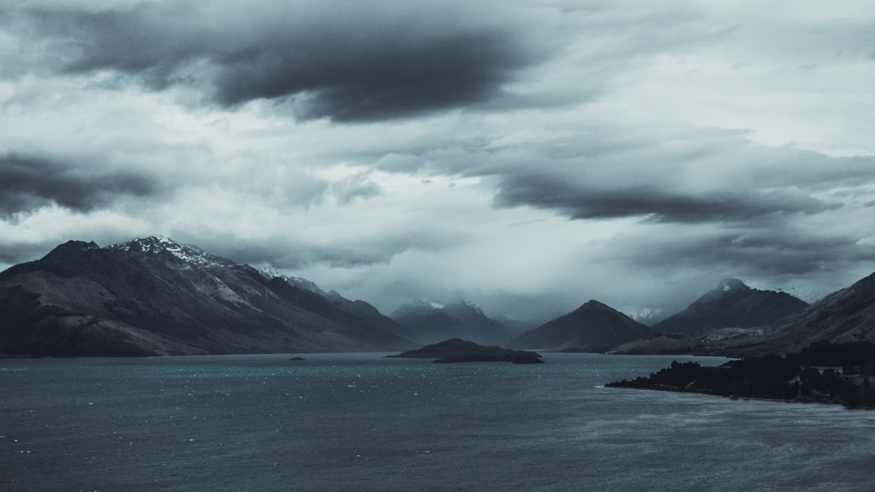 Brown Mountain Under Cloudy Sky