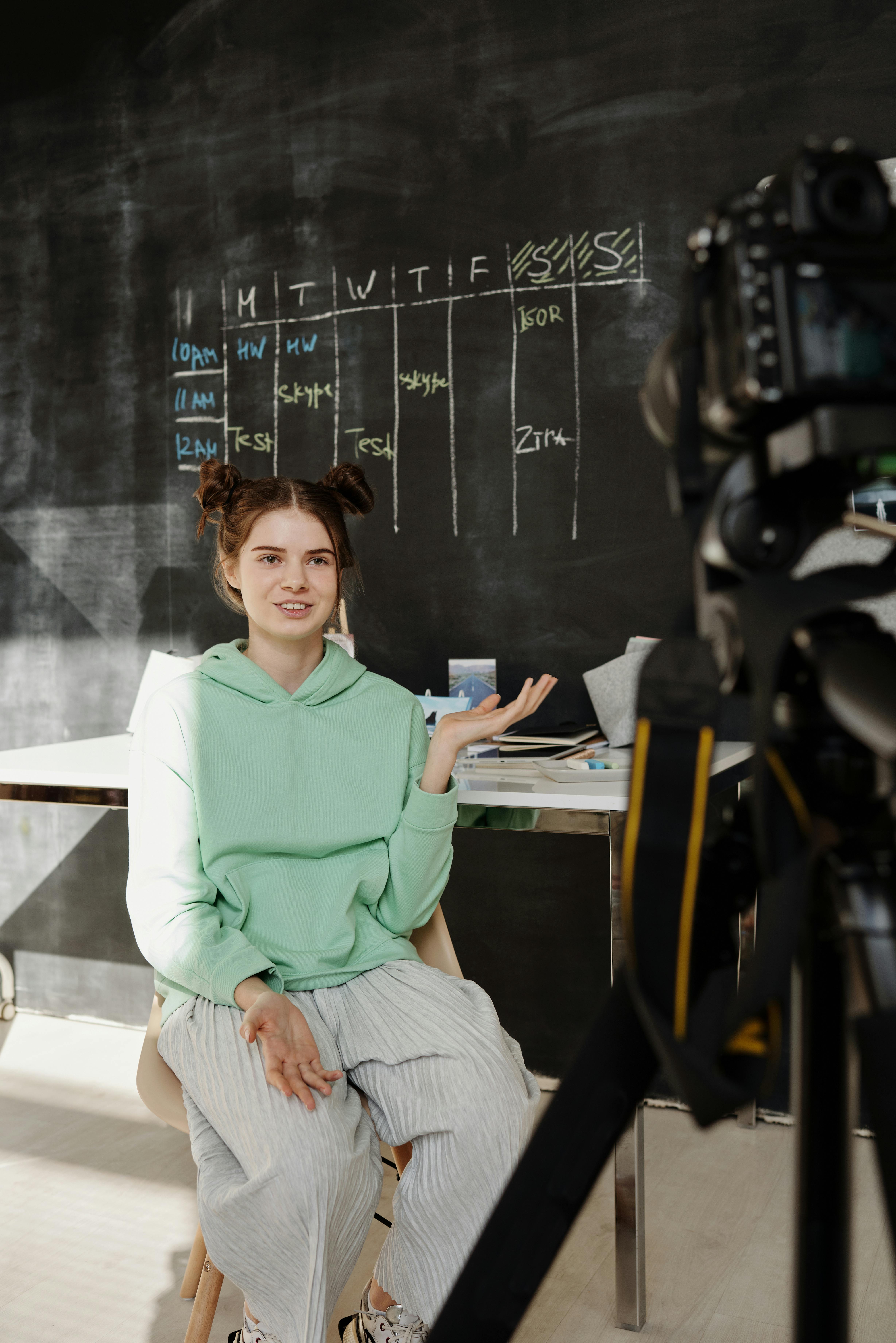 a teenage girl filming a video