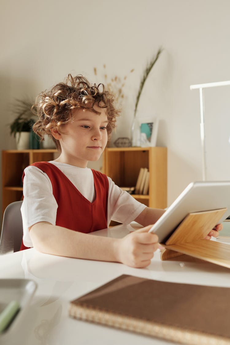 A Boy Studying Using An Ipad