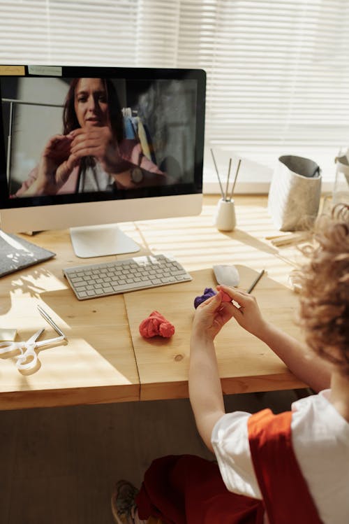 Free Photo Of Kid Playing With Clay While Looking In The Monitor Stock Photo