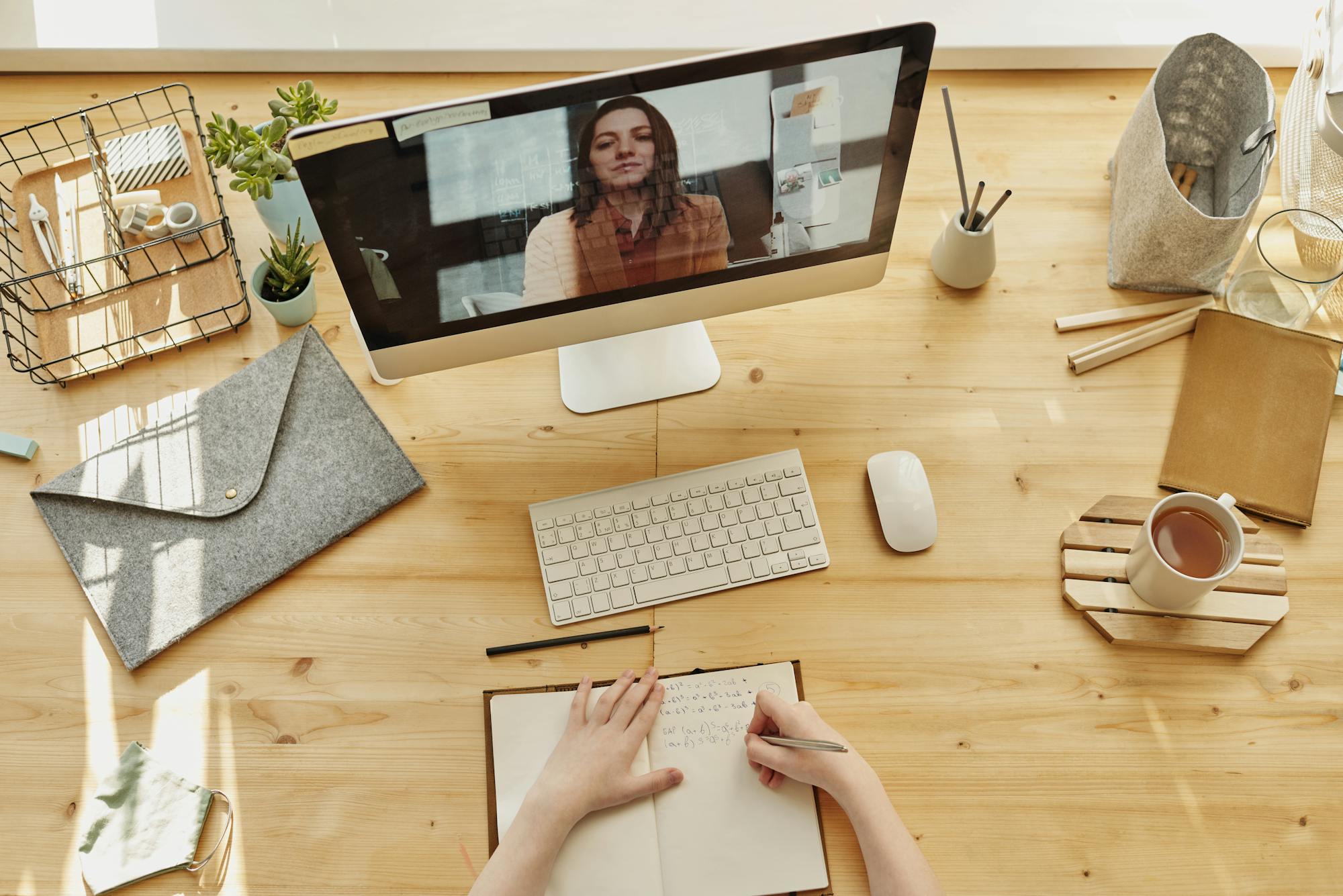 Desk with notebook, phone, and laptop