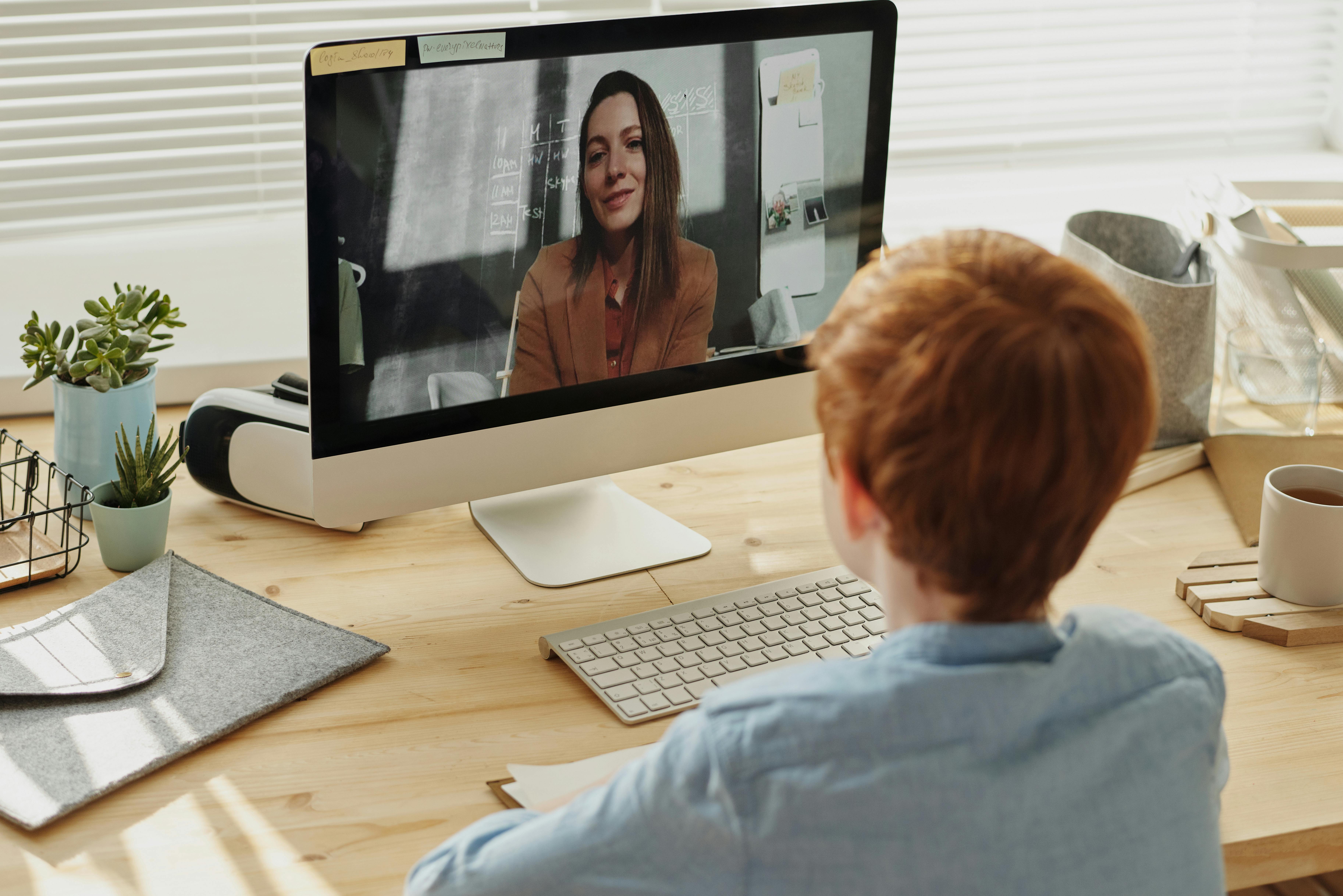 photo of boy video calling with a woman