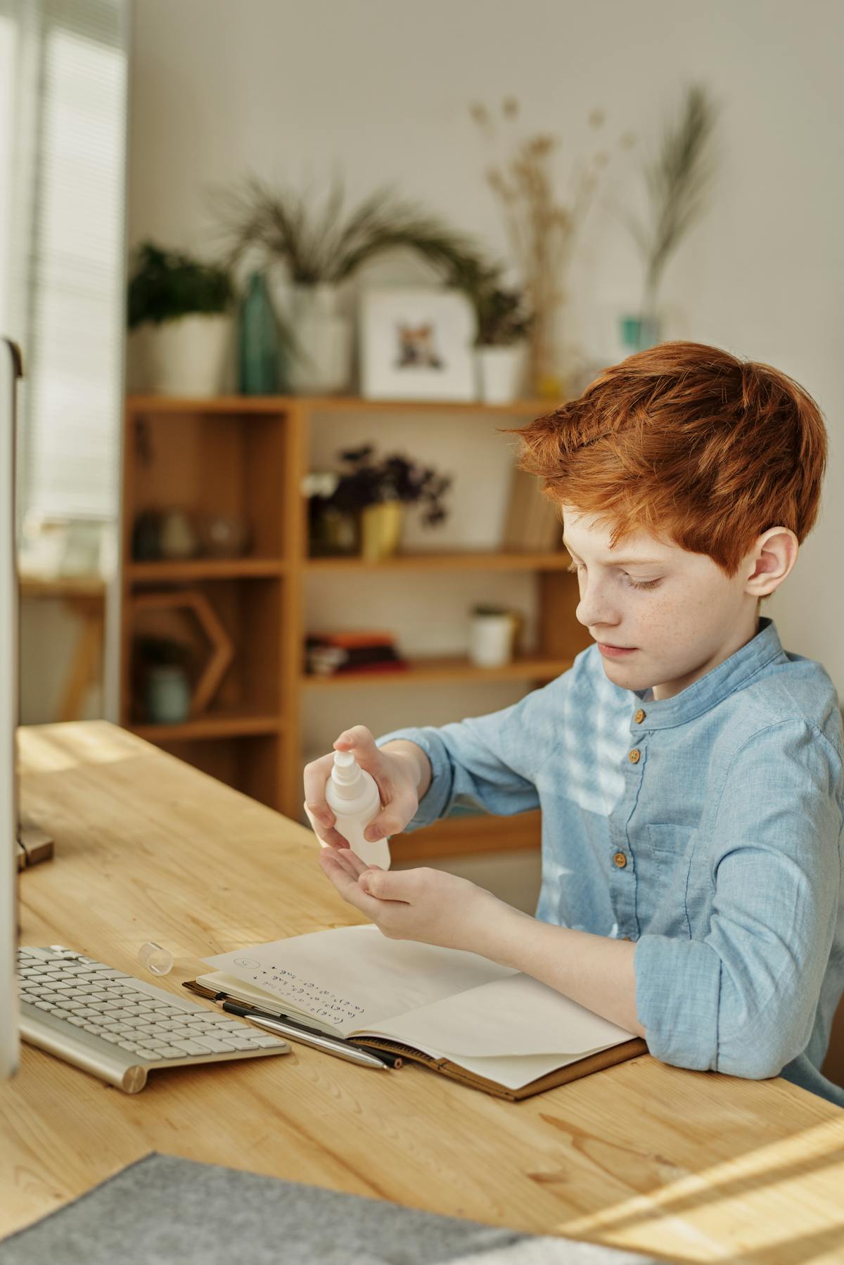Person budgeting using a laptop and notes at a desk