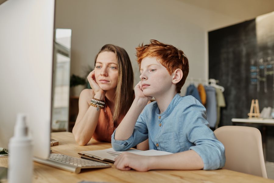 A student working through a lesson with a tutor on a laptop
