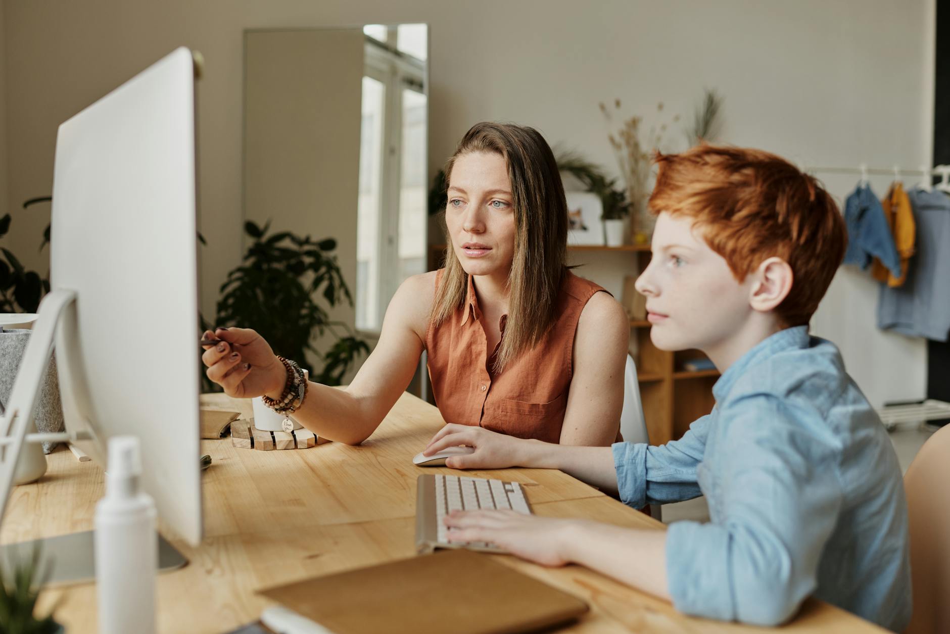 Mother helping Son on a computer