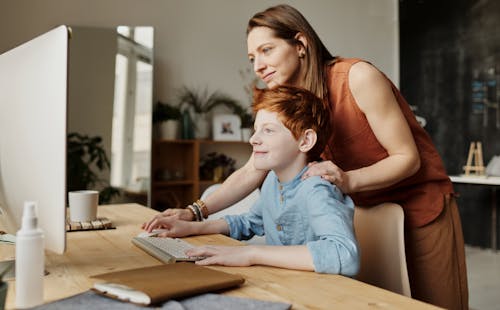 Free Photo of Woman Teaching His Son While Smiling Stock Photo