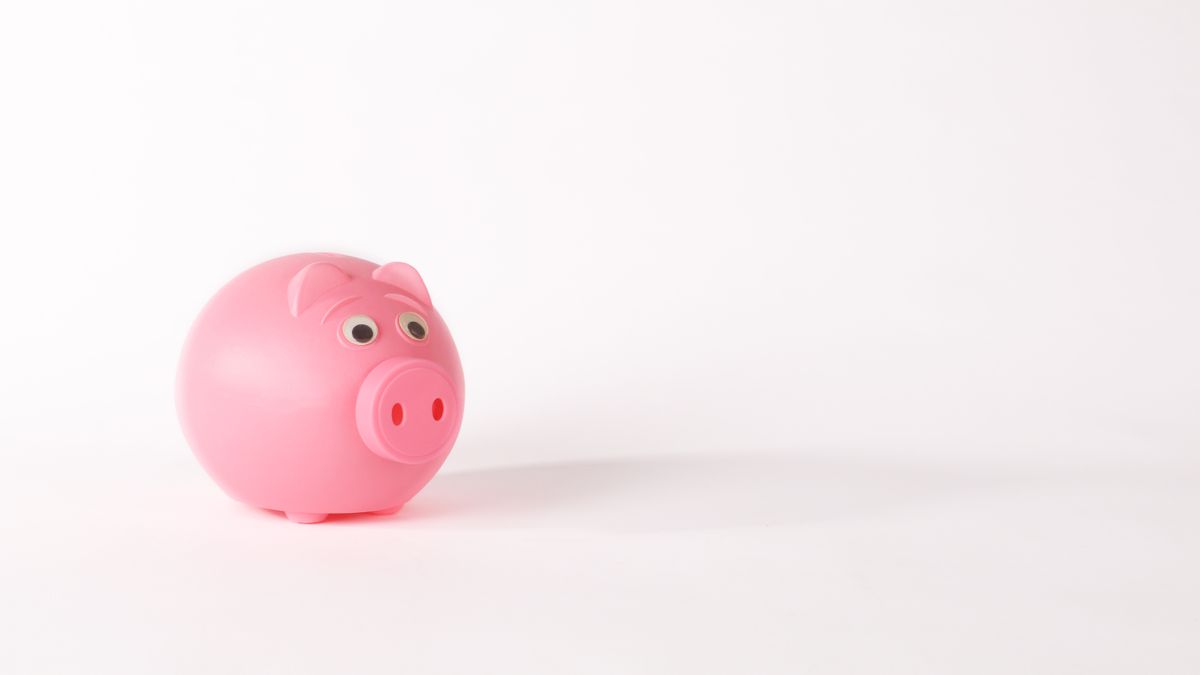 Cute pink piggy bank isolated on white background representing savings and finance concepts.