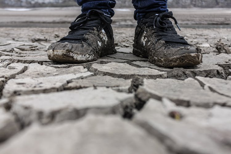 Low-Angle Shot Of Person Wearing Muddy Shoes