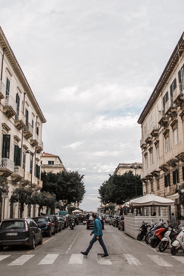 Old City Street With Man Crossing Road