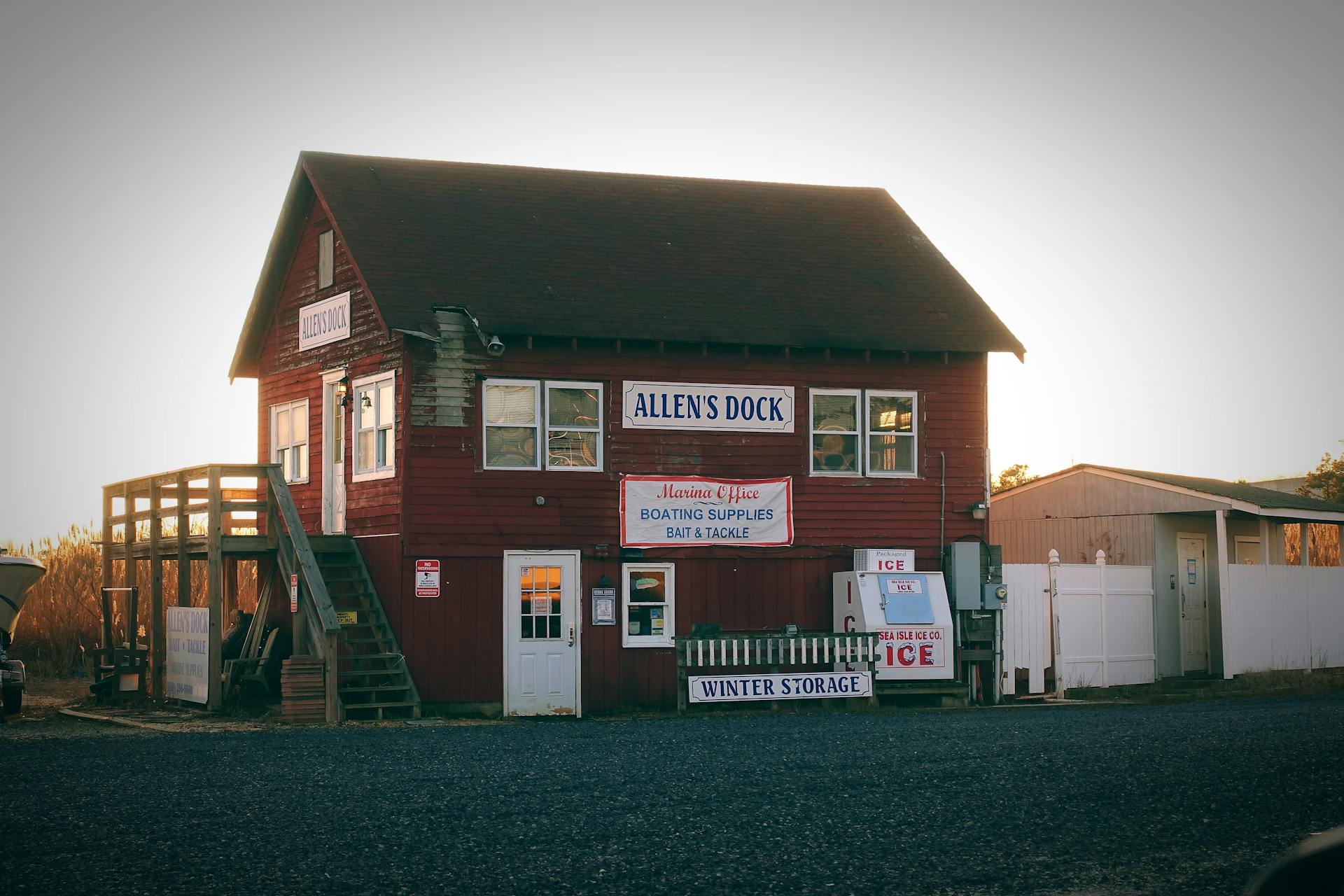 Charming rustic dock building in Bass River, NJ at sunset, offering boating supplies and services.