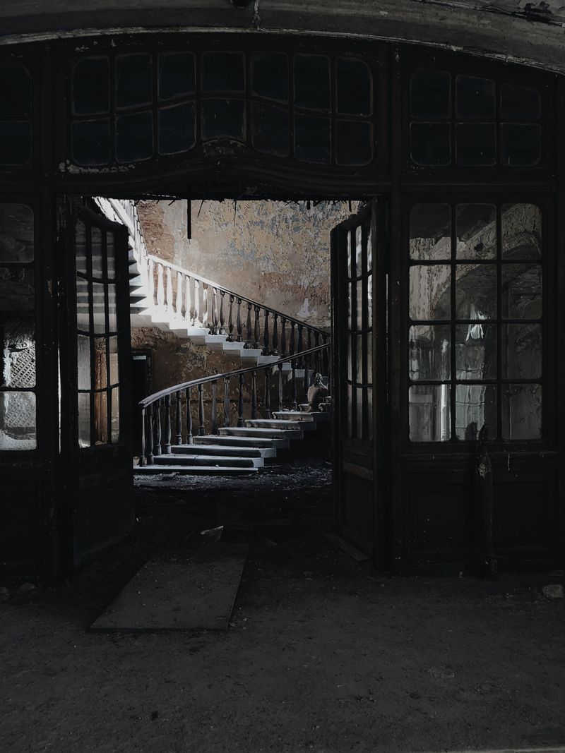 dark decaying house interior spiral staircase