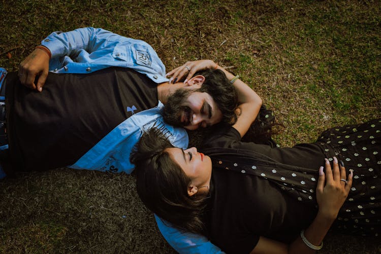 Man And Woman Lying On Grass