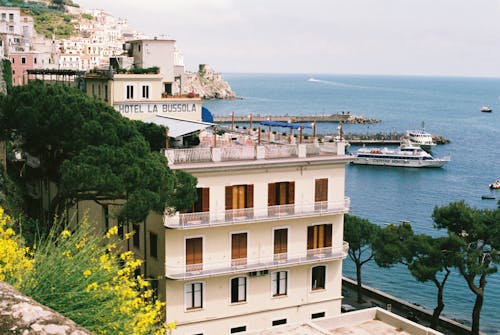 White Concrete Building Near Body of Water