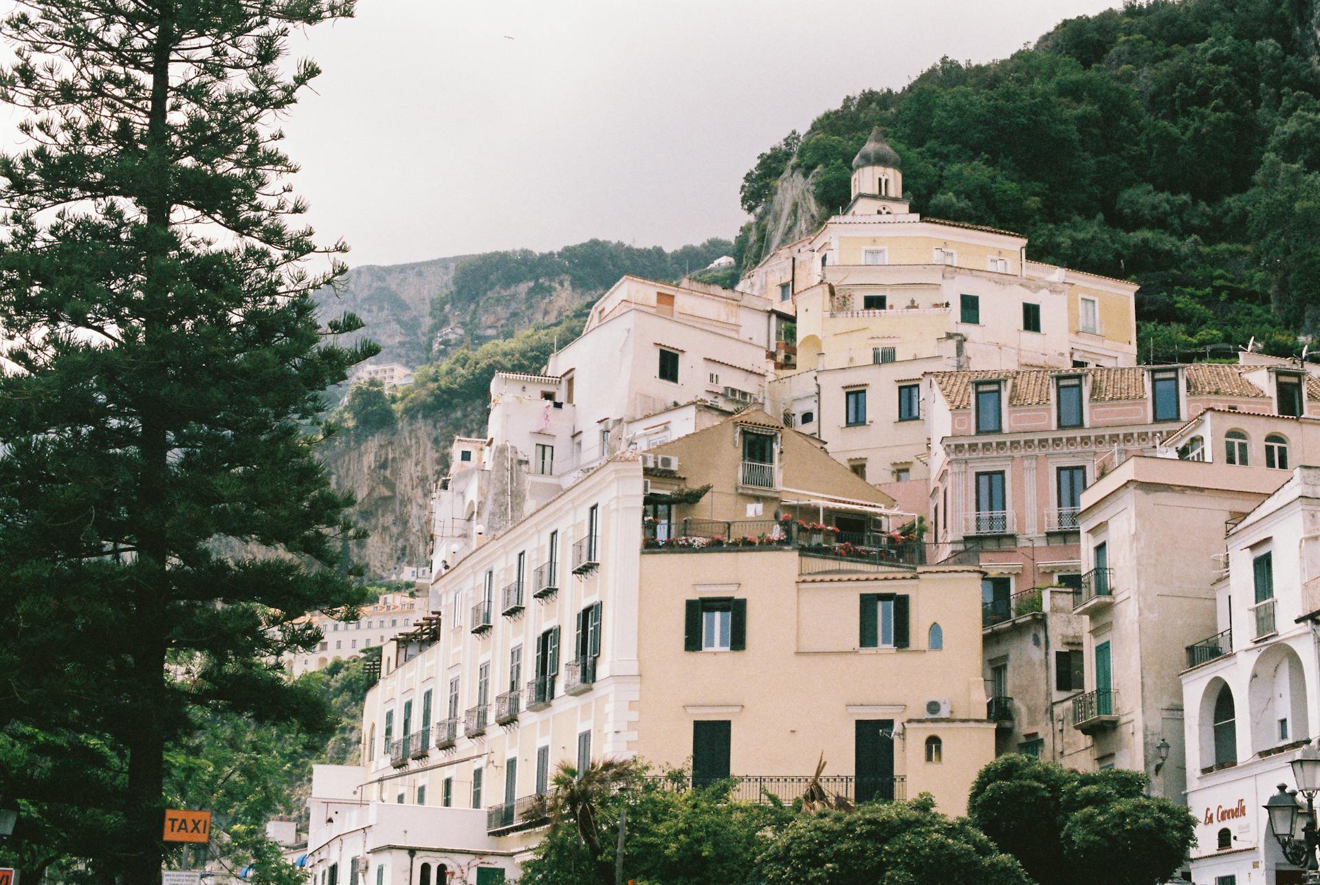 Picturesque Italian townscape with traditional buildings nestled against a lush hillside.