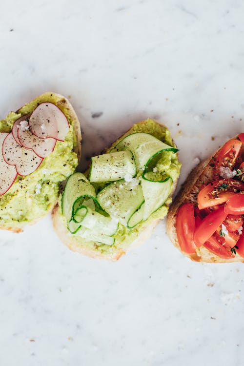 Delicious healthy bruschetta with tomatoes radish cucumber and avocado