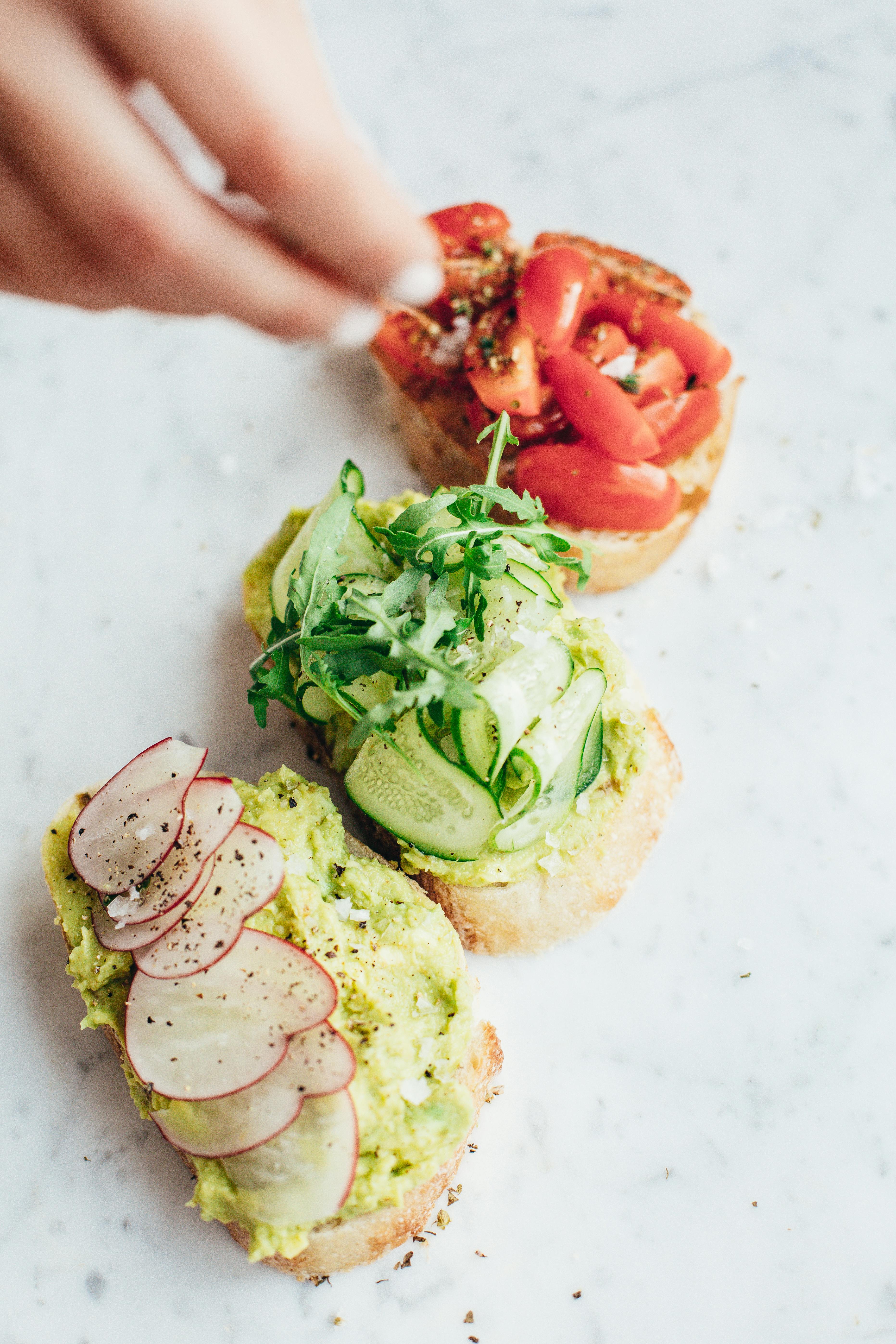 crop person pouring seasoning on appetizers