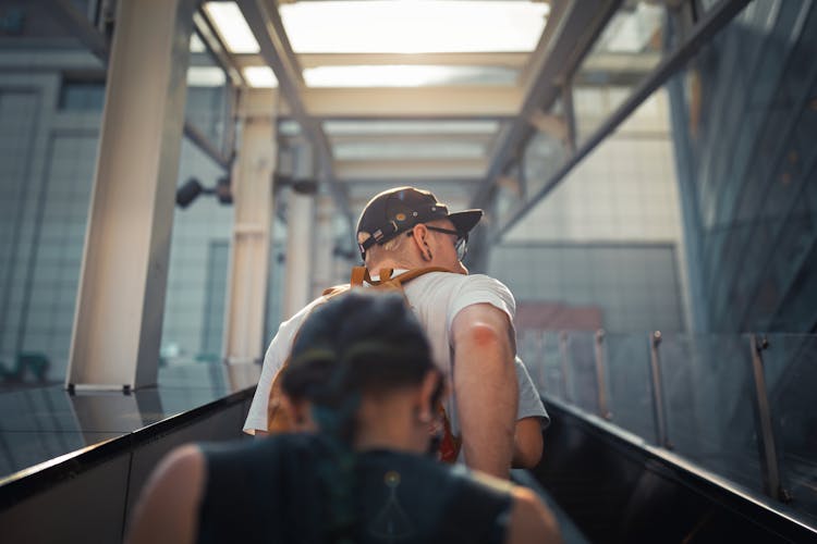 Faceless People Going Up On Escalator