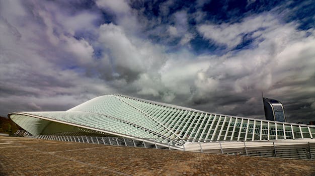 A striking view of futuristic architecture beneath a dramatic cloud-filled sky, highlighting modern design.