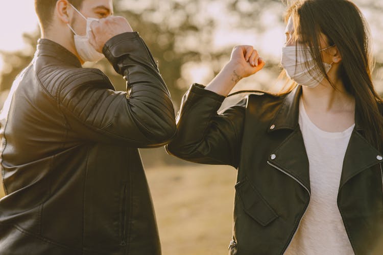 Photo Of Man And Woman Doing Elbow Bump