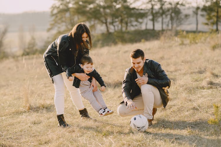 Photo Of Family Playing With Soccer Ball