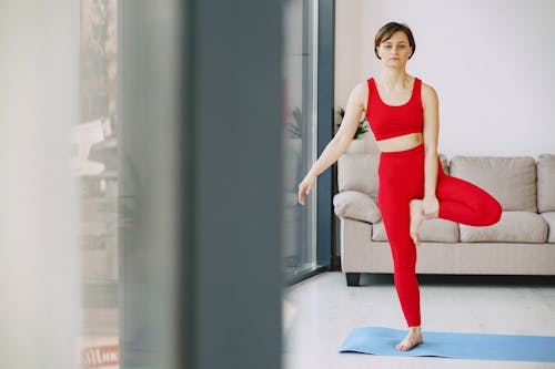 Serious woman doing yoga on mat