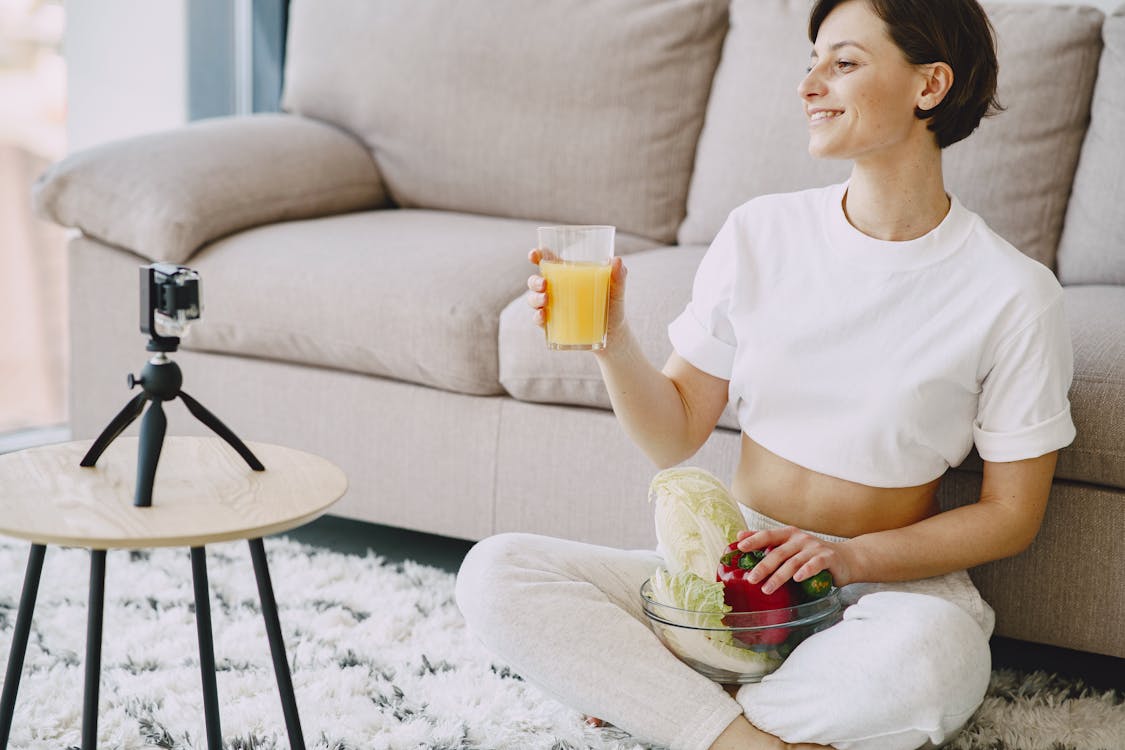 Free Photo of Woman Sitting Near Sofa While Holding Drinking Glass Stock Photo Free Photo of Woman Sitting Near Sofa While Holding Drinking Glass Stock Photo