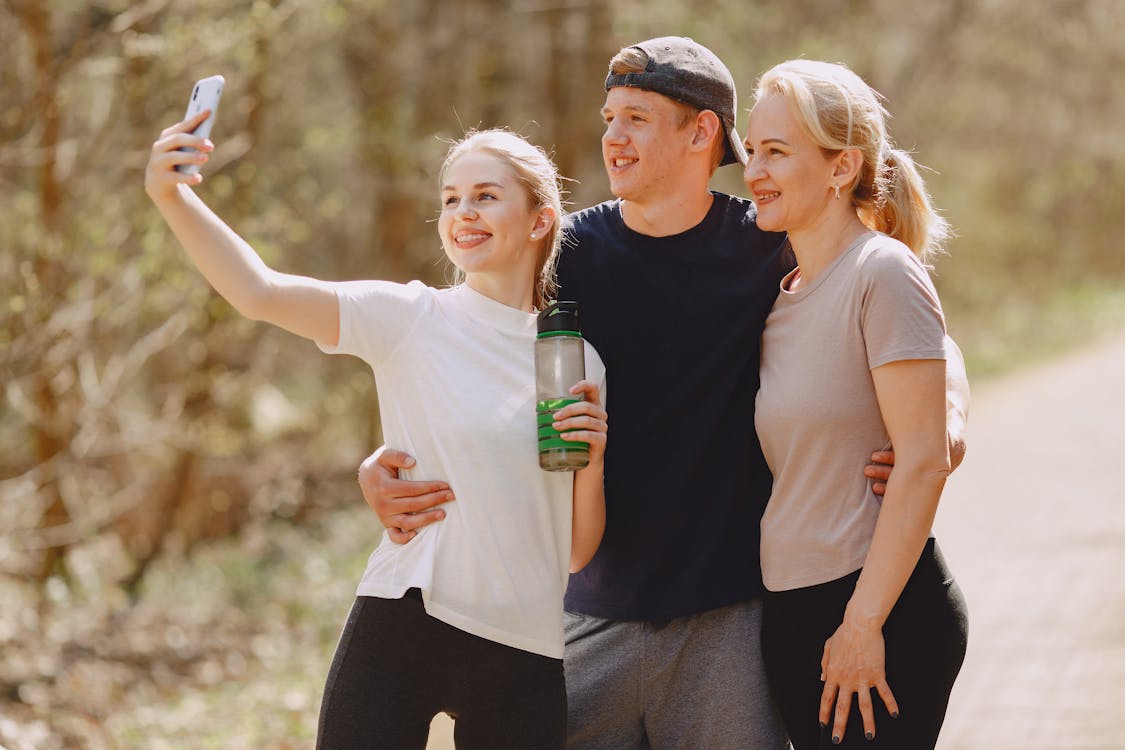 Photo of Man and Women Taking Selfie