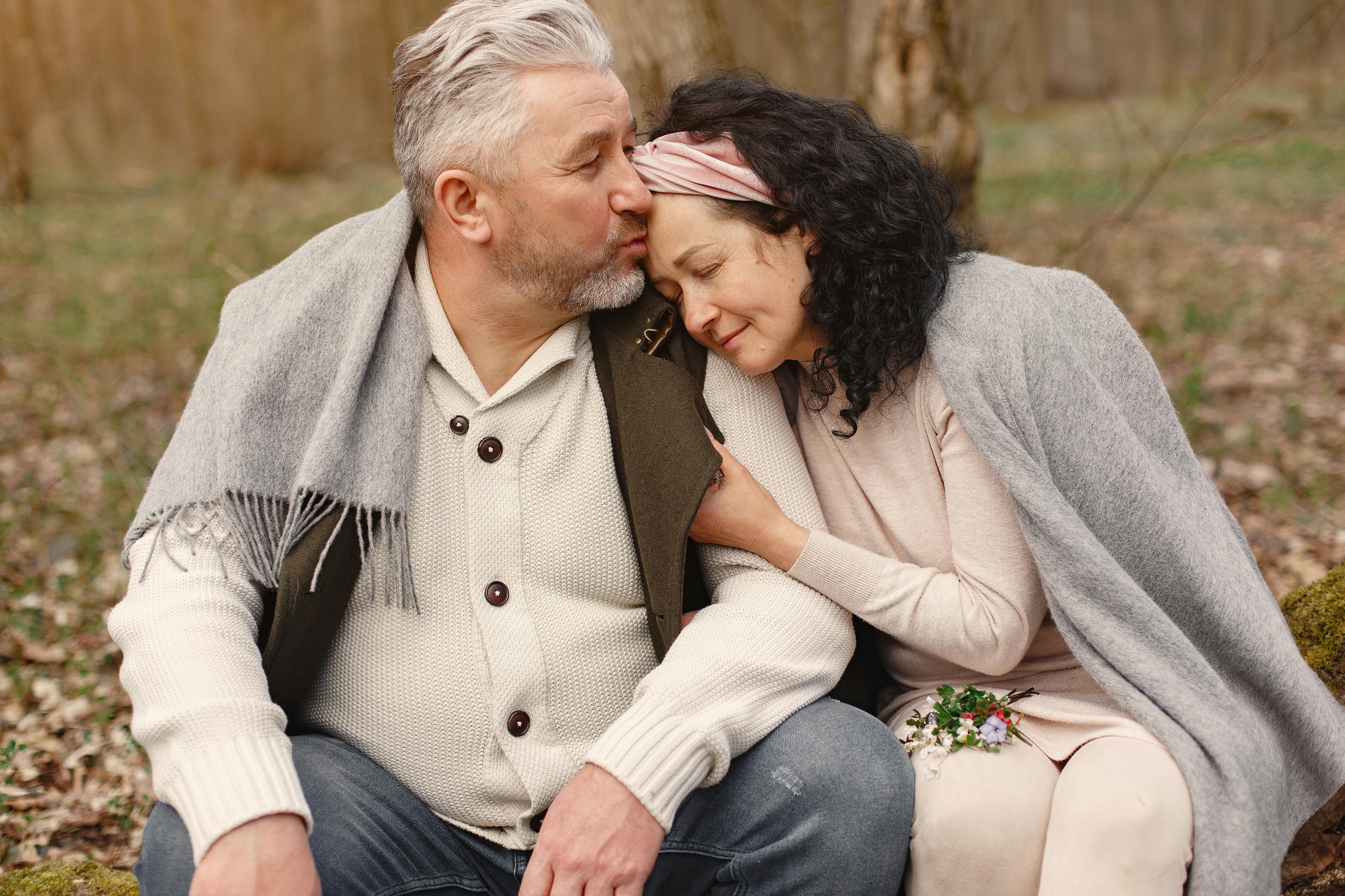 happy senior couple hugging in autumn park