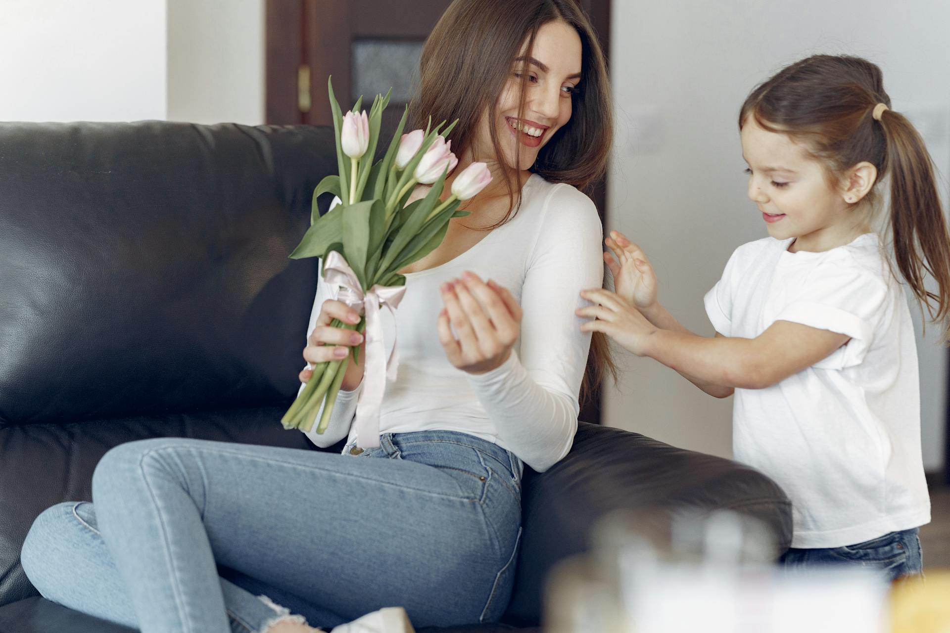 Happy mother and daughter celebrating Mother's Day with flowers