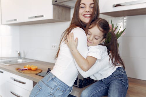 Photo of Mom and Daughter Hugging Each Other