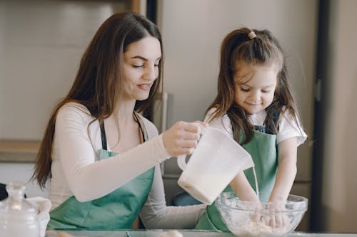 Photo of Woman and Child Baking