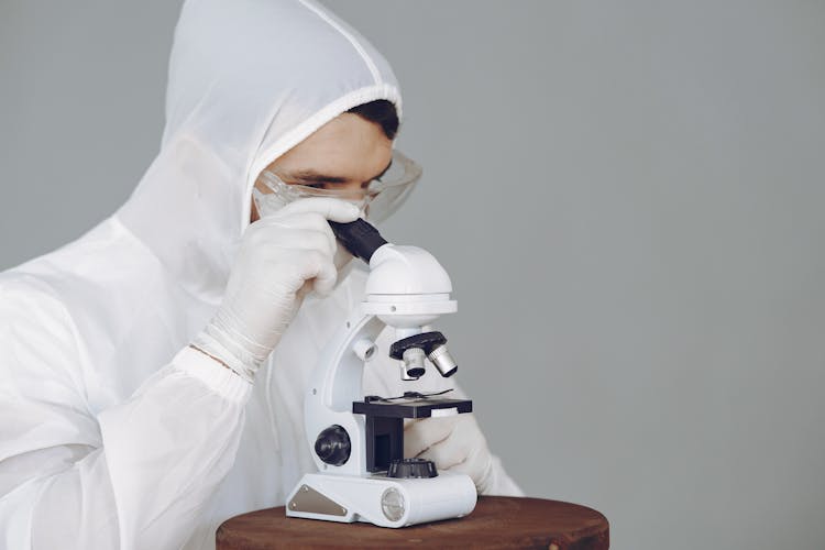 Photo Of Person Using Microscope