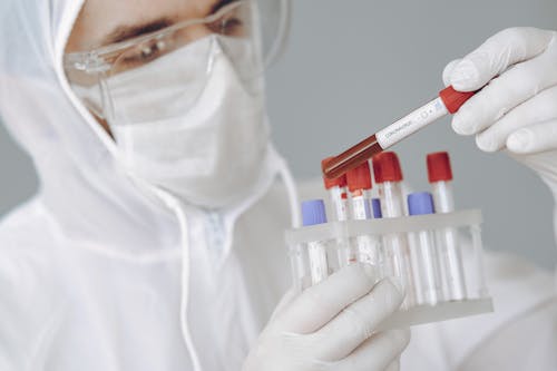 Free Crop scientist holding test tube with positive coronavirus result Stock Photo