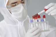 Crop scientist holding test tube with positive coronavirus result