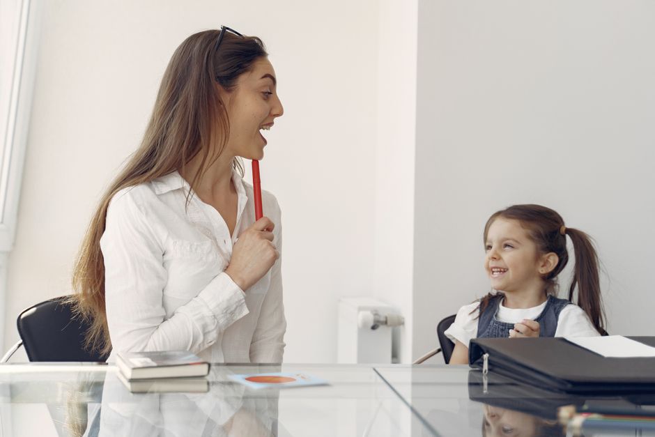 Photo by Gustavo Fring on Pexels Positive female looking after little girl while sitting together at glass table in contemporary workplace and playng - Photo by Gustavo Fring on Pexels