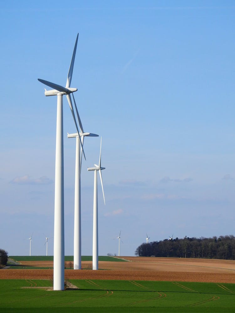 Photography Of Three White Windmills