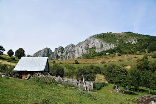 Old rural cottage on green highlands