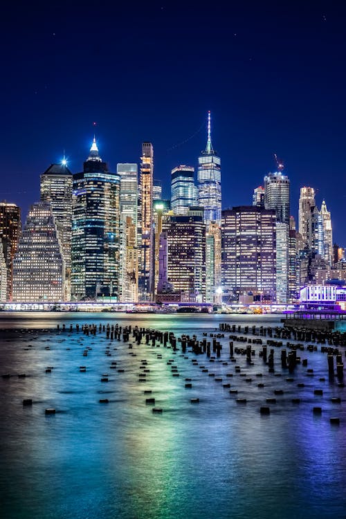 City Skyline during Night Time Near Body of Water