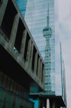 A captivating reflection of CN Tower on a Toronto skyscraper's glass facade.