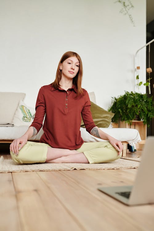 Woman in Red Long Sleeve Shirt Sitting on the Floor